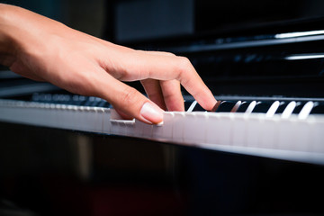 Fototapeta premium Asian male pianist playing piano in recording studio