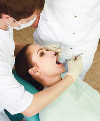 Obraz na płótnie Canvas Young woman with dentist in a dental surgery. Healthcare