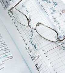 Eyeglasses lying down on a business document