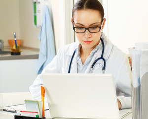 Female doctor working on the laptop