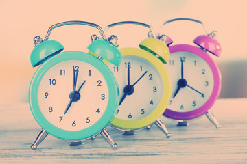 Colorful alarm clocks on table