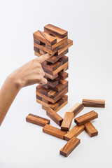 Hand playing with the wood game. on white background.