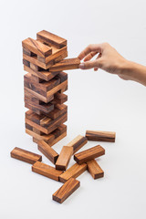 Hand playing with the wood game. on white background.