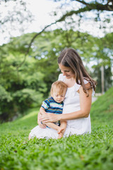 happy mother playing with her son in the park