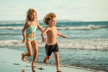 happy kids playing on beach in the day time