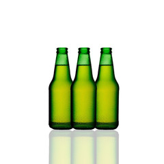 Three isolated green bottles