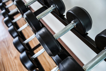 Fototapeta premium Dumb bells lined up in a fitness studio. picture is short focus