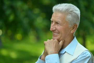 Happy elderly man in summer park