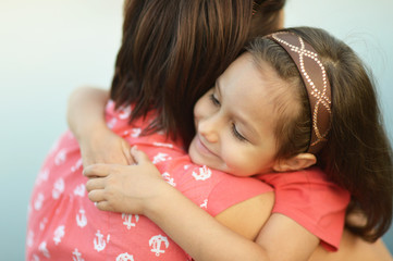 girl hugging her mother