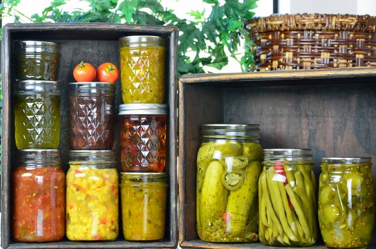 .Jars of home canned vegetables in wooden boxes