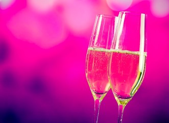 champagne flutes on blue and violet tint light background