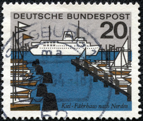 stamp printed in Germany shows harbor with ship and yachts