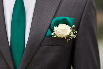 groom jacket with green tie
