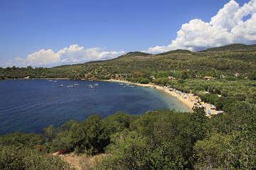 Fototapeta na wymiar Public beach in the beautiful bay of the Aegean Sea.