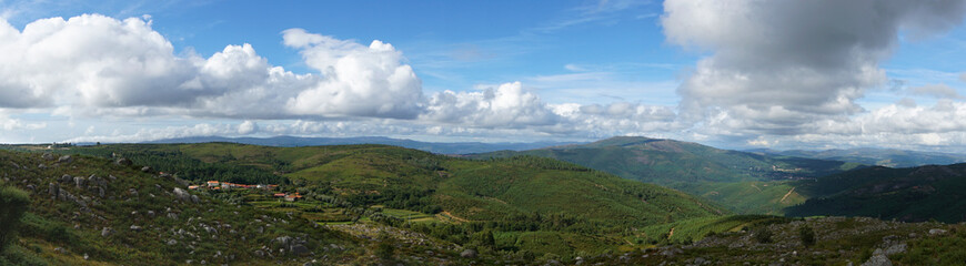 Fototapeta na wymiar Panorama from a ridge on a cloudy summer day