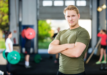 Male Athlete Standing Arms Crossed At Gym