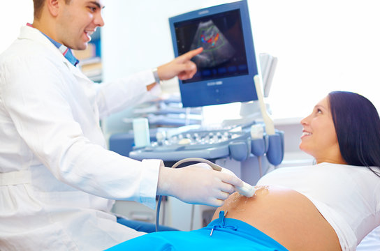 doctor conducting the ultrasound diagnostic to pregnant woman