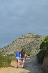 Girls walking up mountain