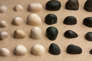 Fototapeta na wymiar Stones sticking out of the sand