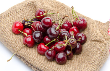 Red ripe cherries on burlap