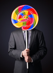 Businessman holding a lollipop
