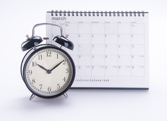 Fototapeta na wymiar alarm clock with calendar. alarm clock with calendar on the back