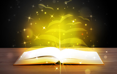 Open book with golden glow flying paper pages