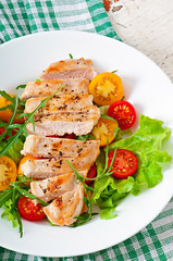 Grilled chicken breasts and fresh salad