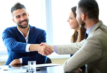 Business people shaking hands, finishing up a meeting 