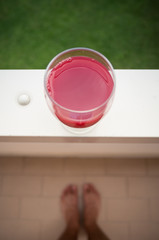 red drink on balcony