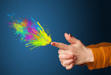 Colorful splashes are coming out of gun shaped hands