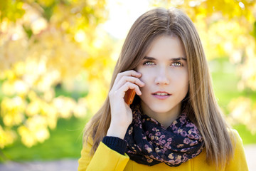 Happy beautiful woman calling by phone