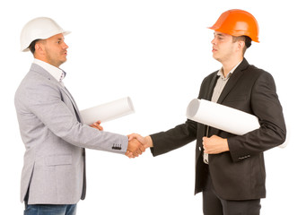 Young Engineers Shaking Hands Holding Blueprints