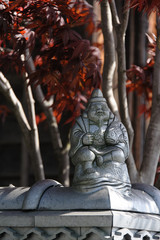 Japanese figurine with a fish on a fence in the province