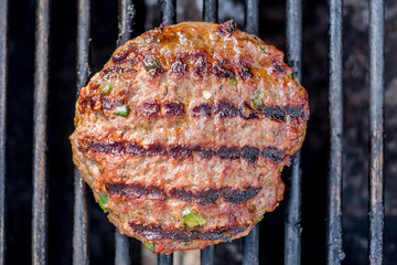 Hamburgers on the grill with stripes outdoors