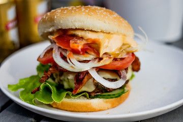 Grilled hamburger with bacon on a white plate