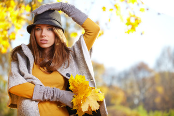 Beautiful autumn woman in golden park