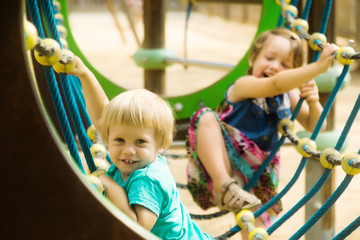 Fototapeta na wymiar Two sisters at action-oriented playground