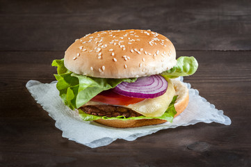 hamburger on a napkin on wooden table