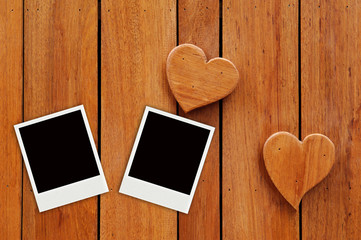 two photo on hearts wooden background