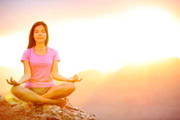 Yoga woman meditating at sunset in Grand Canyon
