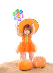 little girl in orange costume with pumpkins