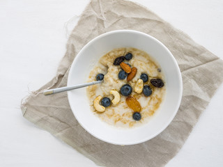 Oatmeal porridge with fresh blueberry, honey and nuts