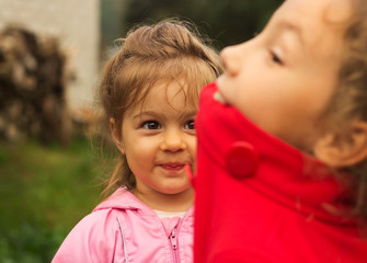 joyful sisters playing  with big expressions in a park