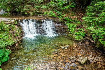 Mountain stream forming a water cascade