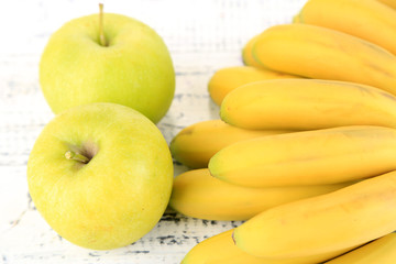 Bunch of mini bananas and green apples