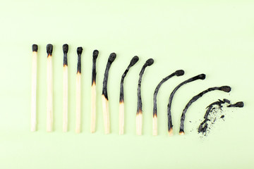matches in different stages of burning, on color background