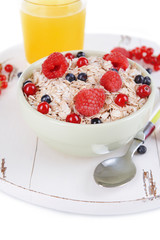 Tasty oatmeal with berries in bowl close-up