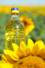 Bottle of oil with sunflower close up