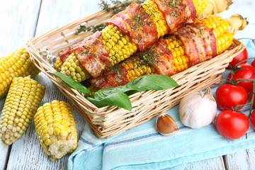 Grilled bacon wrapped corn on table, close-up